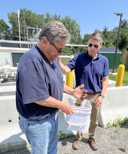 Jon Rulfs handles the dried material his farm uses for cow bedding